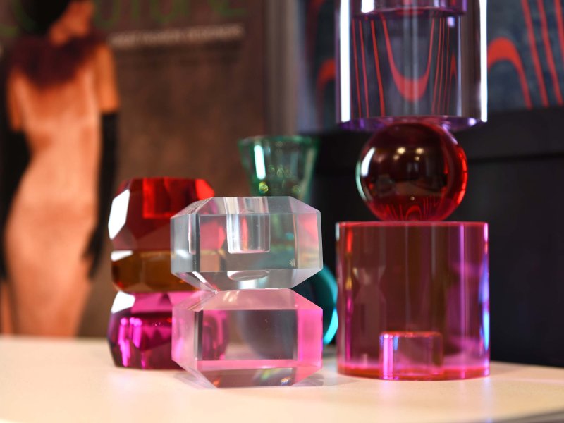 Colorful glasses with lids on a brown table